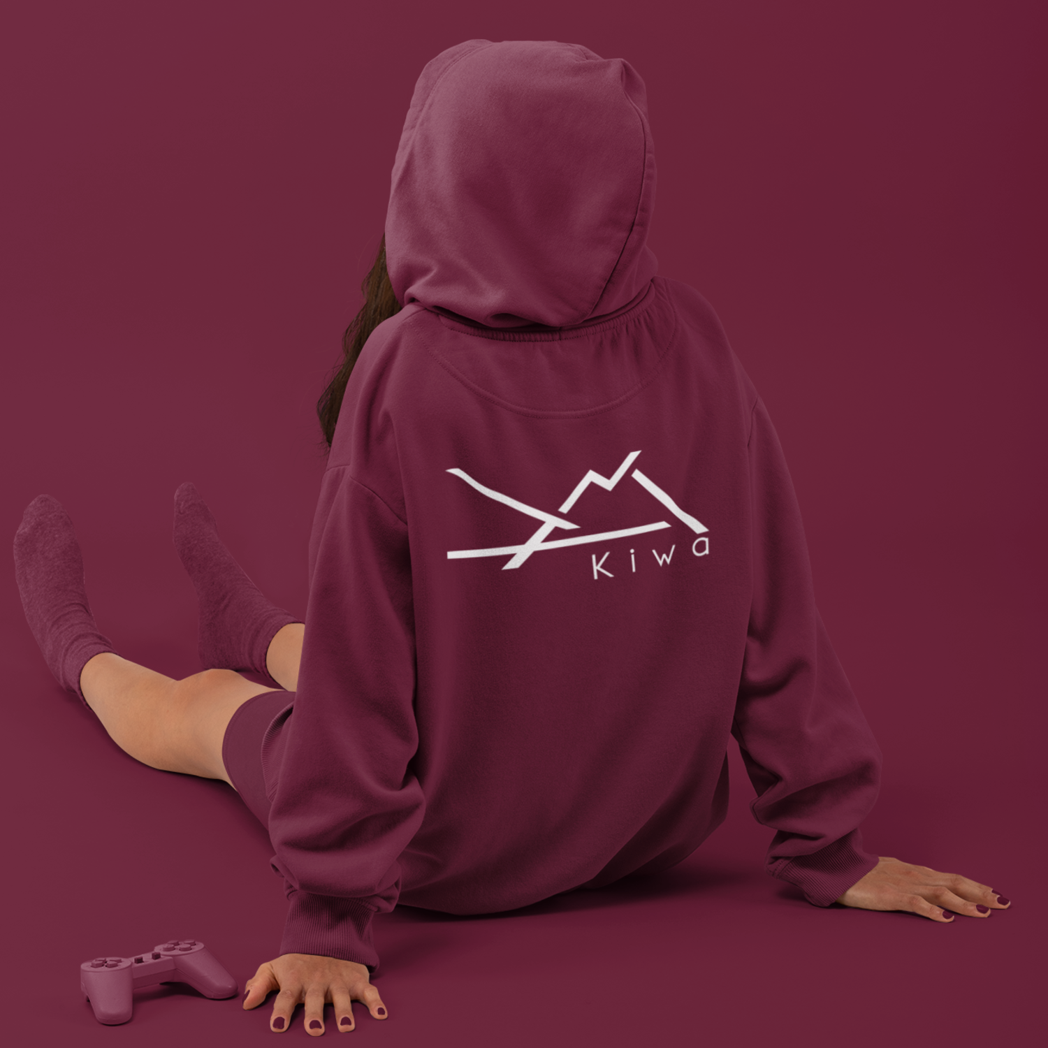 Sweat à capuche KIWA bordeaux porté par une femme, vue de dos avec logo montagne, vêtement lifestyle sud-ouest.
